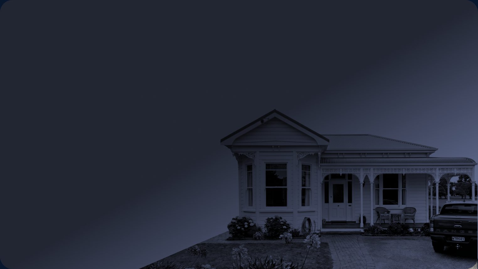 Weatherboard villa at dusk with a ute parked in the driveway